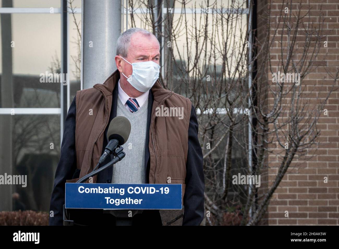 New Jersey Gov. Phil Murphy addresses the press at Rowan College of South Jersey in Sewell, N.J., Jan. 11, 2020. Soldiers are assisting in temperature checks, registration, guiding individuals through the building, and monitoring people after they received their vaccinations. Stock Photo