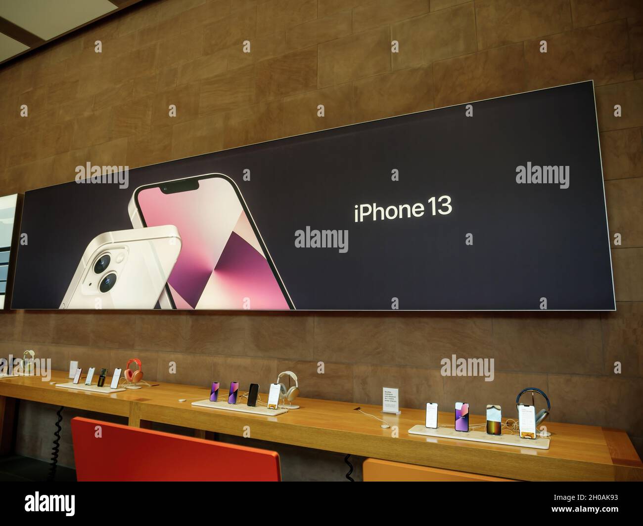 large poster of iPhone 13 at the Apple Store as latest new 5G