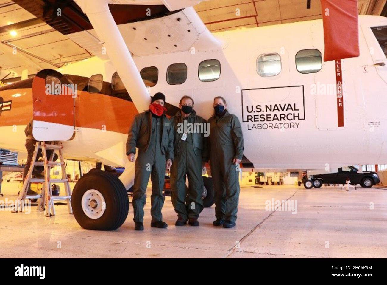 U.S. Naval Research Laboratory researchers Damien Josset, Ph.D., NRL oceanographer, Stephen Sova, NRL technician, and Stephanie Cayula, NRL physical scientist from the laboratory’s Ocean Sciences Division gather for a group photo Jan. 11 prior to conducting airborne lidar research in Homer, Alaska. Stock Photo