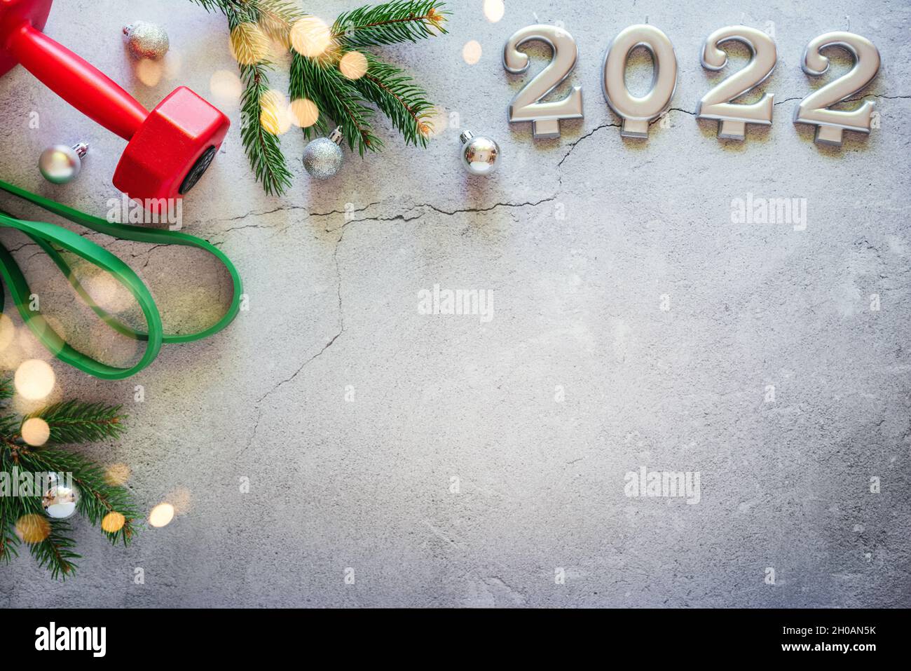 Red dumbbell, resistance bande, Christmas tree branches with Christmas