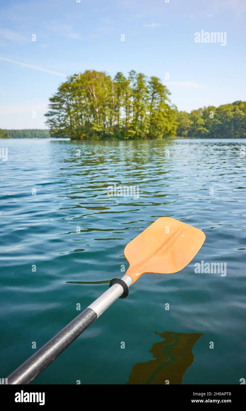 Kayak paddle over the water, ecotourism concept, selective focus. Stock Photo