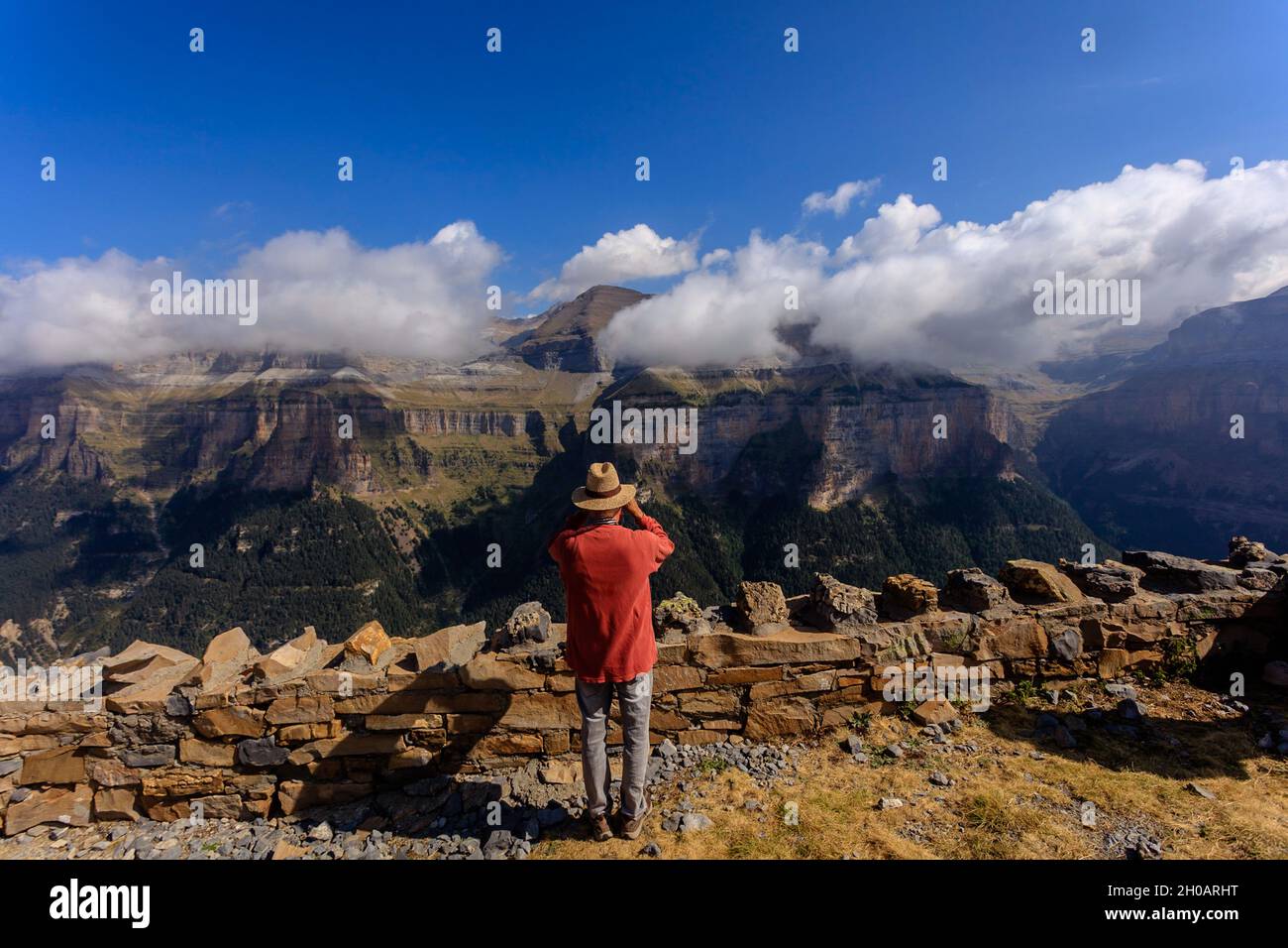 A visitor takes a picture in the Ordesa National Park from one of the observatories. Stock Photo