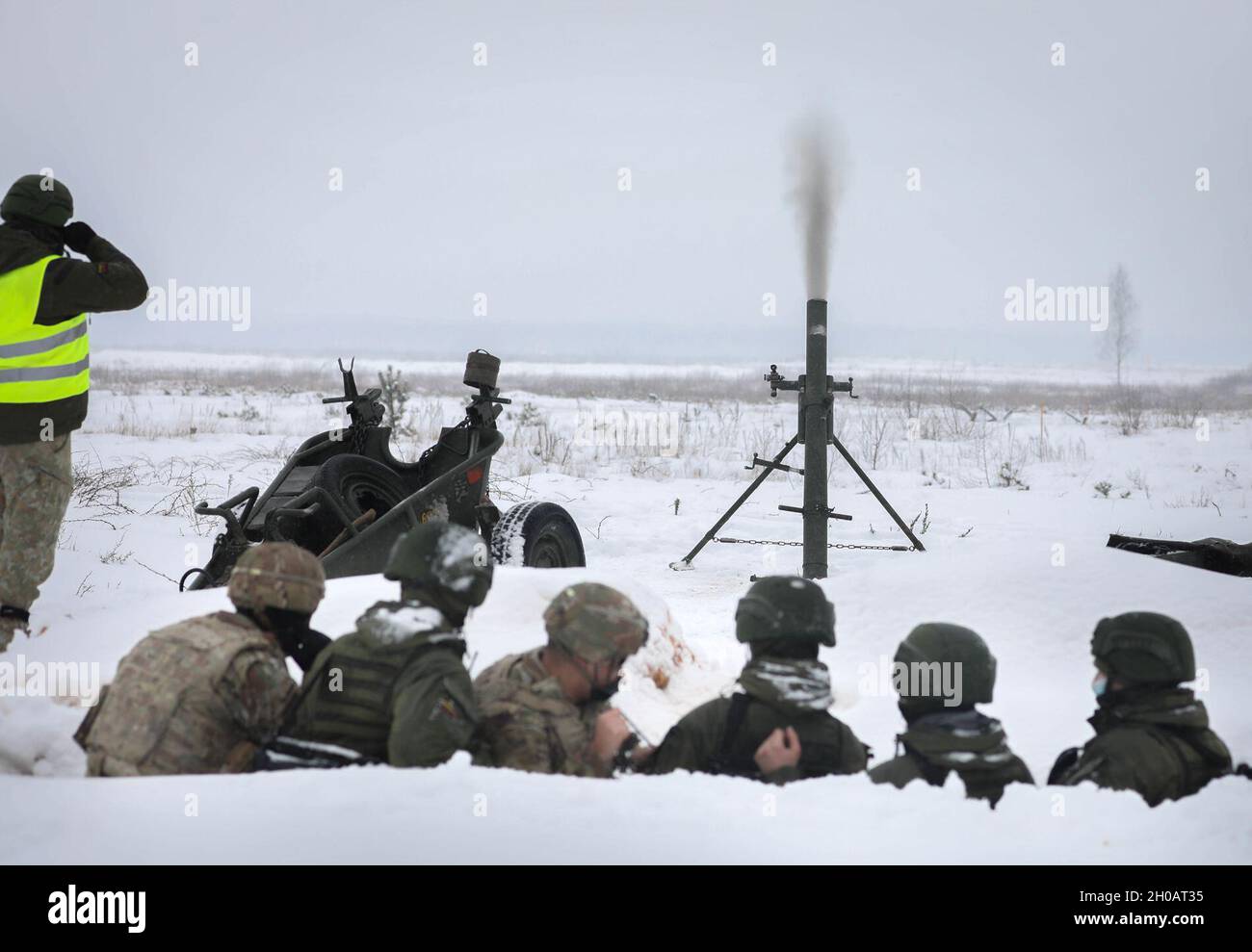 U.S. Capt. Spenser Swafford, 2nd Battalion, 8th Cavalry Regiment fire support officer, fires a Lithuanian 120 mm mortar system during a joint training events Jan. 31, 2021, at Kazlu Ruda, Lithuania. The base is the home of the 22nd Battalion of the Lithuanian Land Forces Motorized Infantry “Griffin” Brigade. Lithuanian and U.S. mortar teams were able to get hands-on experience with each other’s mortar systems. While the systems are similar, there are small differences between each system. Stock Photo