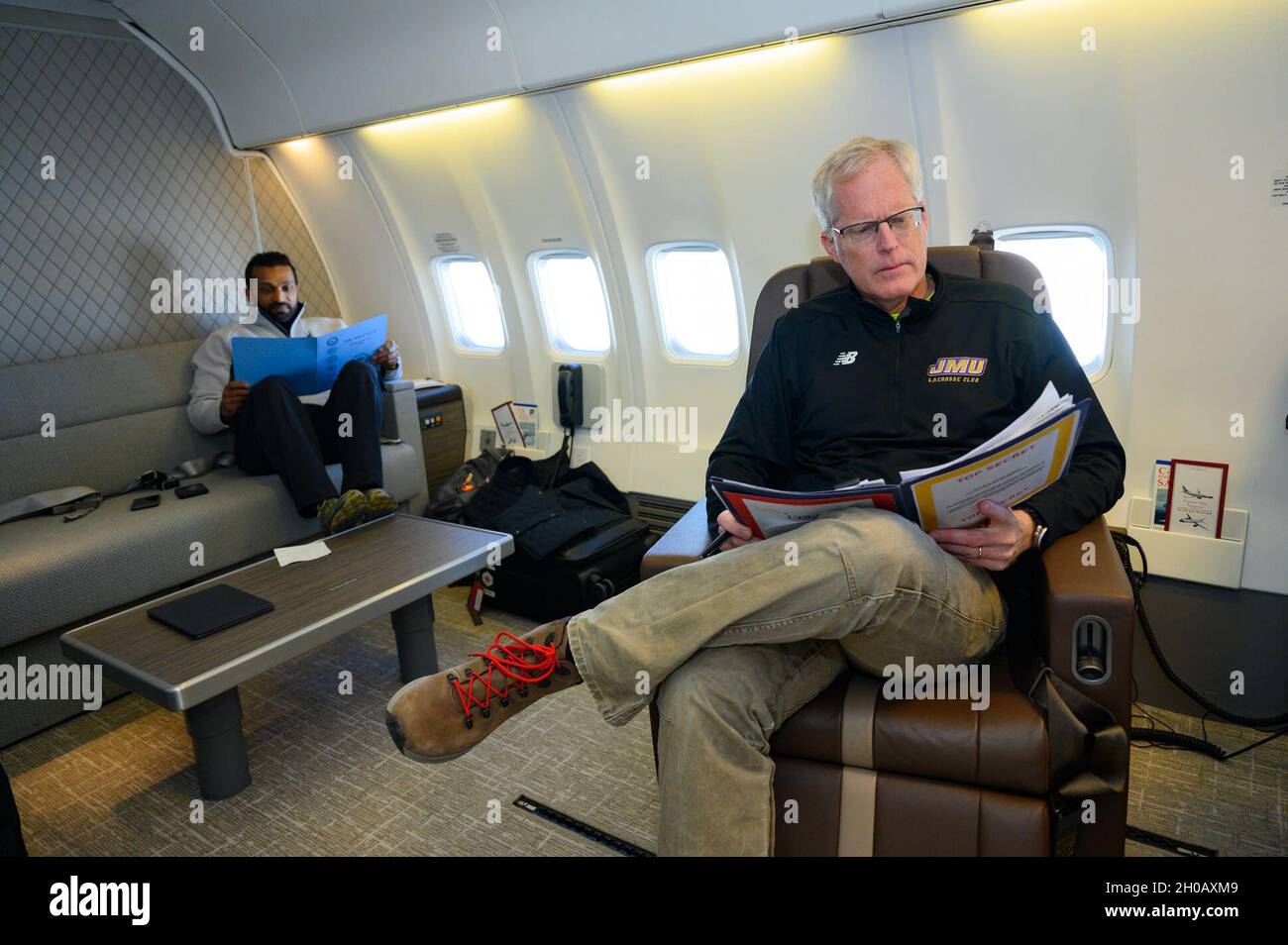 Acting Defense Secretary Chris Miller works in the aircraft cabin with Chief of Staff Kash Patel, after departing Peterson Air Force Base, Colo., Jan. 14, 2021. Stock Photo