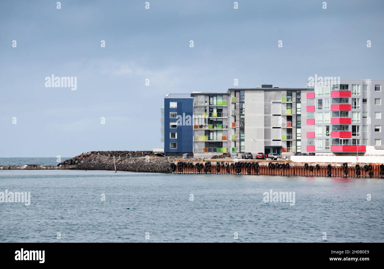 Hafnarfjordur, Iceland - April 4, 2017: Hafnarfjordur coastal landscape with colorful modern living houses on a daytime Stock Photo