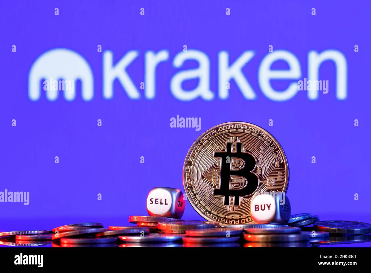 Golden bitcoin with two buy-sell cubes in a pile of coins on the background  of the Kraken logo. The concept of buy-sell choice Stock Photo - Alamy