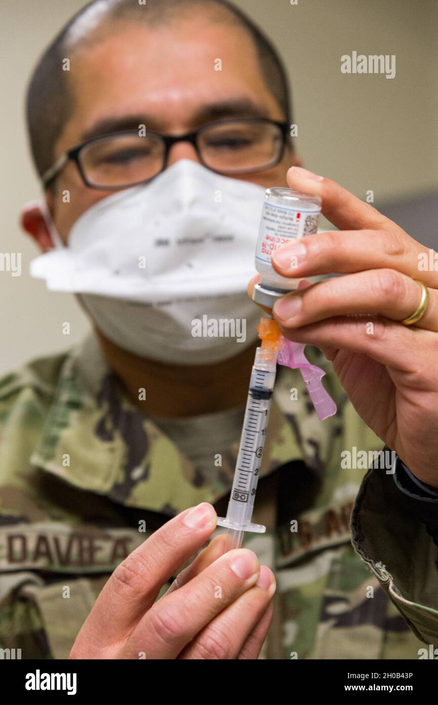 Tech. Sgt. Juan Davila, 436th Operational Medical Readiness Squadron flight operational medicine noncommissioned officer in charge, prepares a single dosage of the COVID-19 vaccine Jan. 15, 2021, at Dover Air Force Base, Delaware. Davila prepared syringes to be administered to the first Team Dover frontline workers who volunteered to receive the vaccine and were identified as eligible in concurrence with Department of Defense guidance. Stock Photo