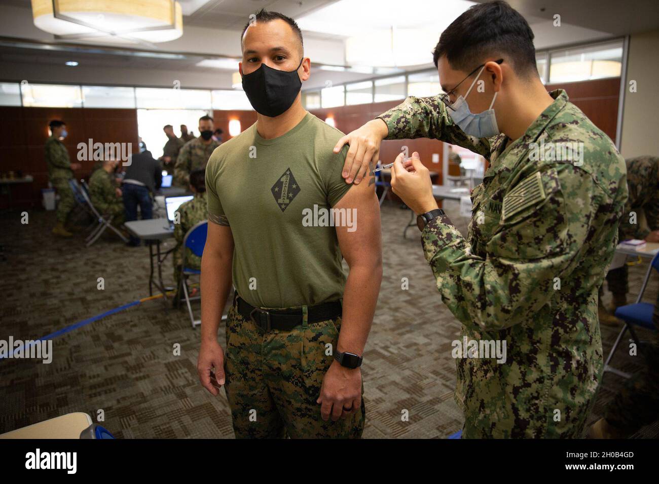 U.S. Marine Corps Col. Daniel Skuce, commanding officer for 11th Marine Regiment, 1st Marine Division, receives the COVID-19 vaccination on Marine Corps Base Camp Pendleton, California, Jan. 15, 2021. The vaccine will help protect service members against COVID-19 and maintain medical readiness throughout 1st Marine Division. Stock Photo