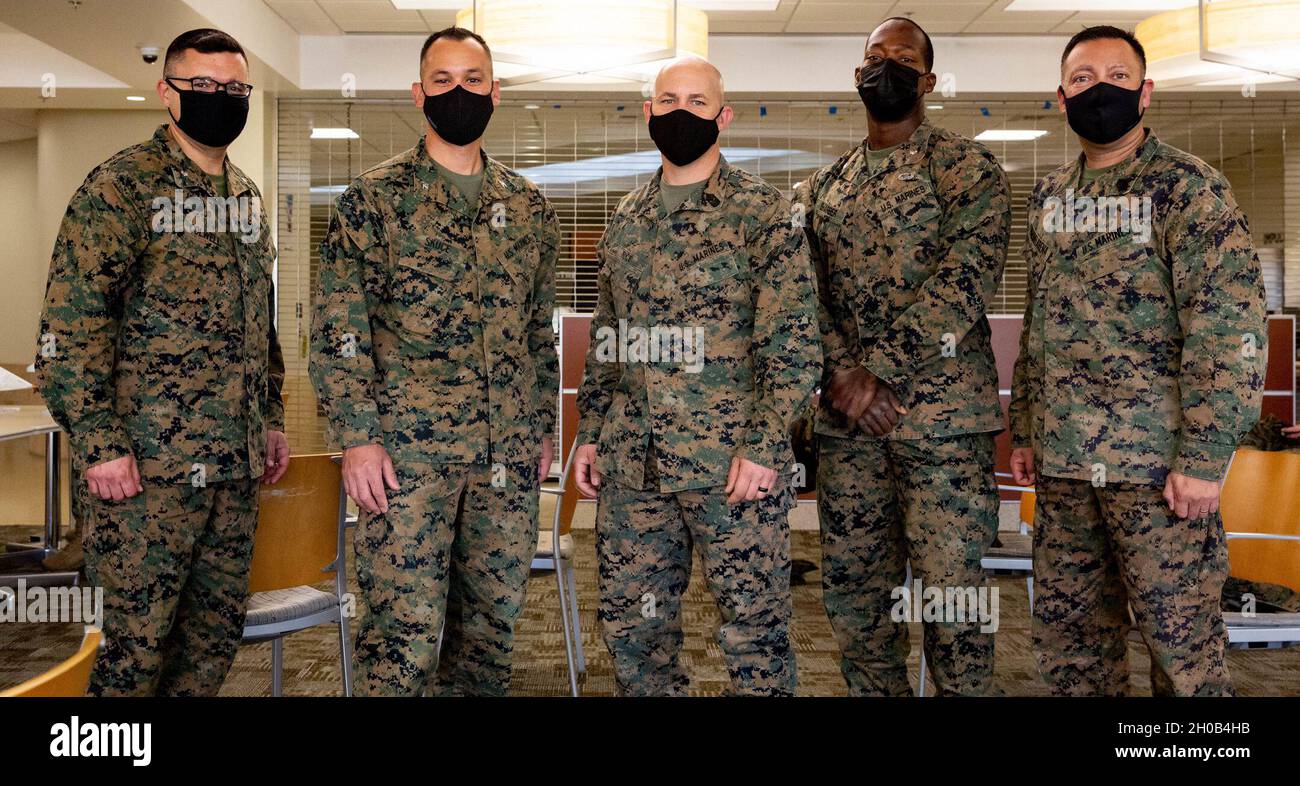 U.S. Marines with Headquarters Battery, 11th Marine Regiment, 1st Marine Division, from left, Lt. Col. Jeremy Colwell, operations officer, Col. Daniel Skuce, commanding officer, Sgt. Maj. Curtis A. Rice,  sergeant major, Lt. Col. Morris M. Sharber Jr., executive officer, and Master Gunnery Sgt. David Marinelarena, a field artillery chief, pose for a group photo after receiving the COVID-19 vaccination on Marine Corps Base Camp Pendleton, California, Jan. 15, 2021. The vaccine will help protect service members against COVID-19 and maintain medical readiness throughout 1st Marine Division. Stock Photo
