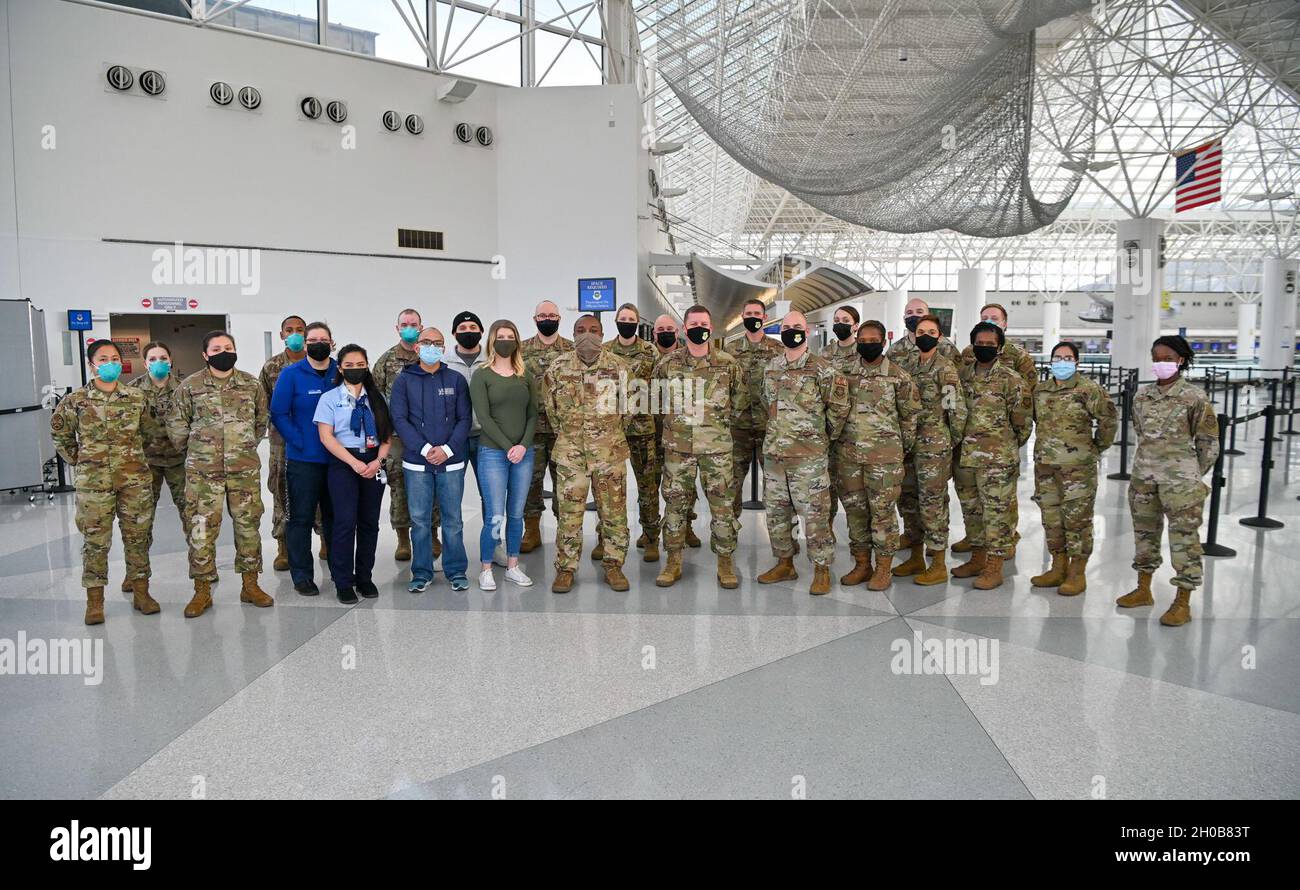 Members of the Patriot Express COVID-19 testing crew pose for a photo with 436th Airlift Wing leaders at the Baltimore/Washington International Thurgood Marshall Airport in Baltimore, Maryland, Jan. 15, 2021. The site provides on-site rapid COVID-19 testing for service members and their families for official travel overseas. This operation helps ensure U.S. Transportation Command’s continued fulfillment of national security requirements while providing for the health and safety of service members, families and international partners. Stock Photo