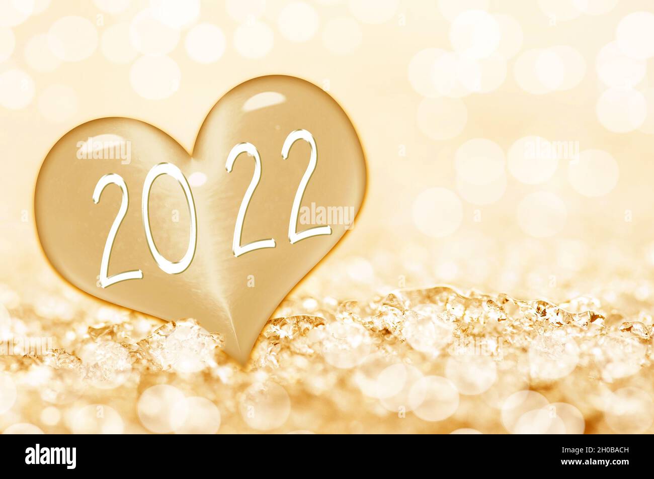 2022 new year card, close up on a ice heart in the snow Stock Photo