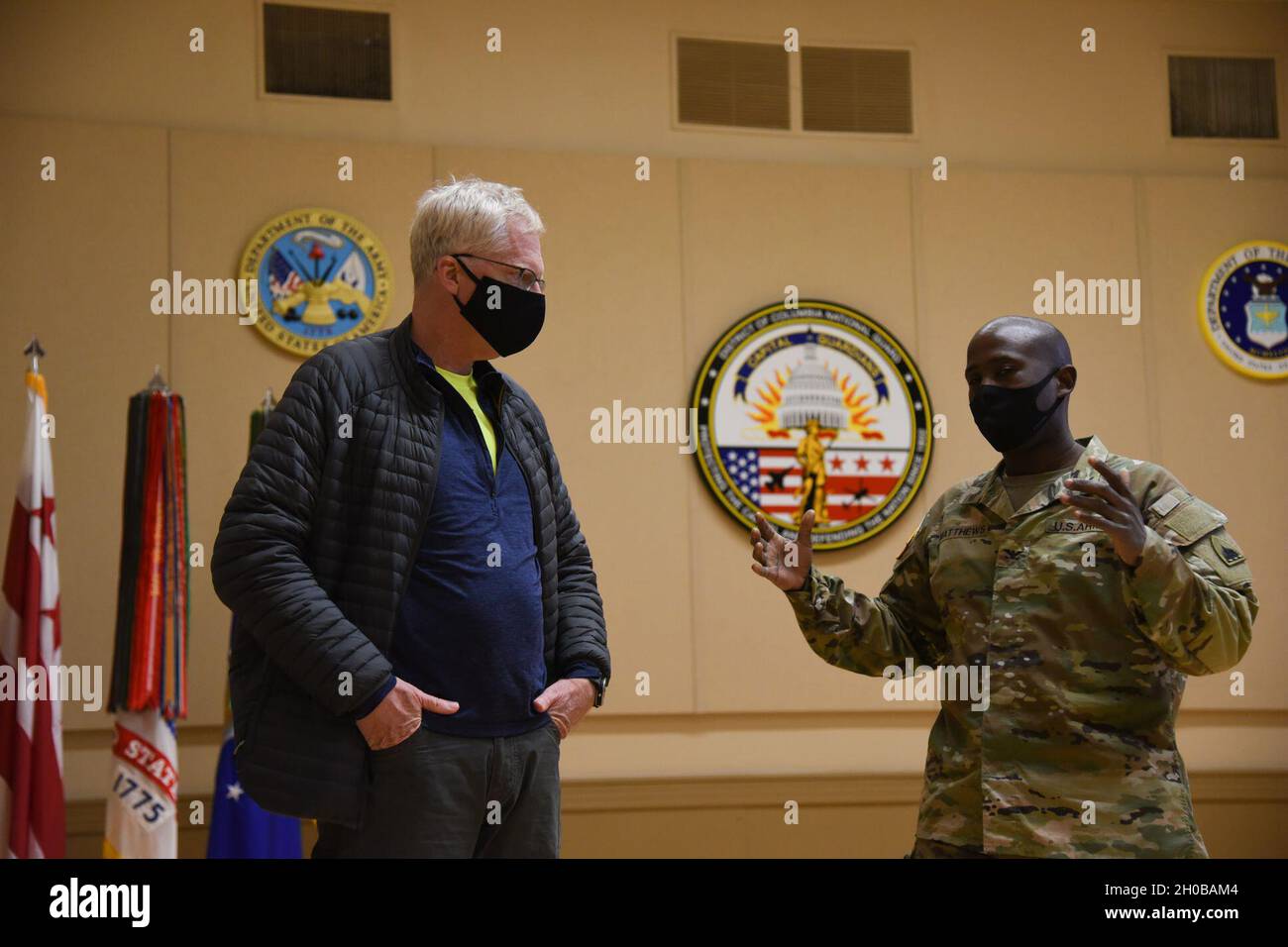 U.S. Army Col. Earl G. Matthews, right, staff judge advocate with Joint Force Headquarters, District of Columbia National Guard, speaks with Christopher C. Miller, the acting secretary of defense, at the D.C. Armory in Washington, D.C., Jan. 16, 2021. At least 25,000 National Guard men and women have been authorized to conduct security, communication and logistical missions in support of federal and District authorities leading up and through the 59th Presidential Inauguration. Stock Photo