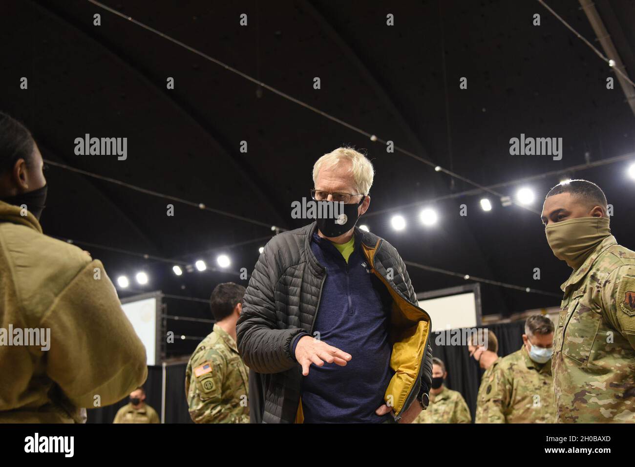 Christopher C. Miller, the acting secretary of defense, speaks with U.S. Air Force Staff Sgt. Darian Quinn, left, and Senior Airman Jordan Heard, assigned to the Florida Air National Guard’s 125th Fighter Wing in Jacksonville, at the District of Columbia Armory in Washington, D.C., Jan. 16, 2021. At least 25,000 National Guard men and women have been authorized to conduct security, communication and logistical missions in support of federal and District authorities leading up and through the 59th Presidential Inauguration. Stock Photo