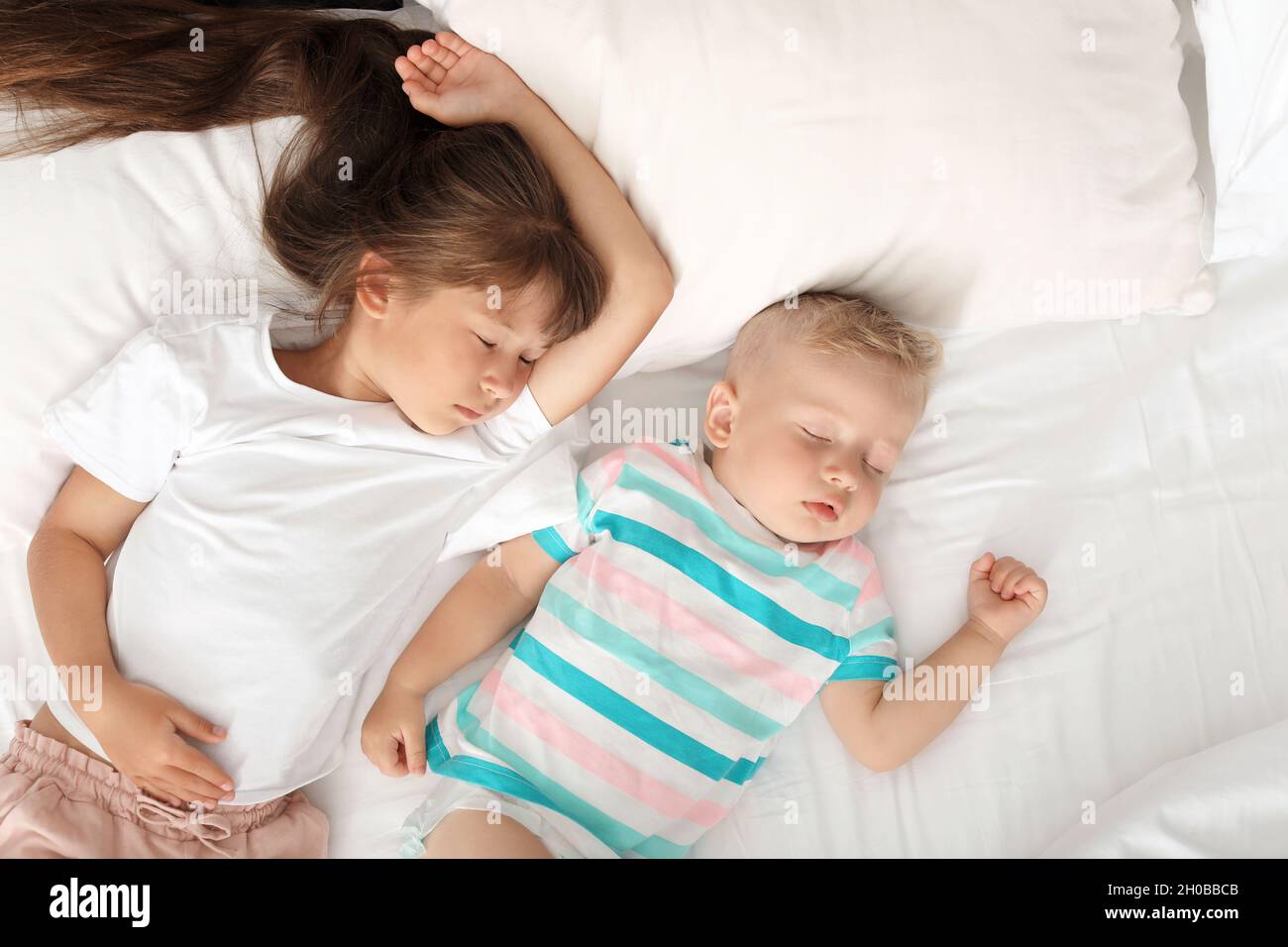 Little children sleeping in bed at home Stock Photo Alamy