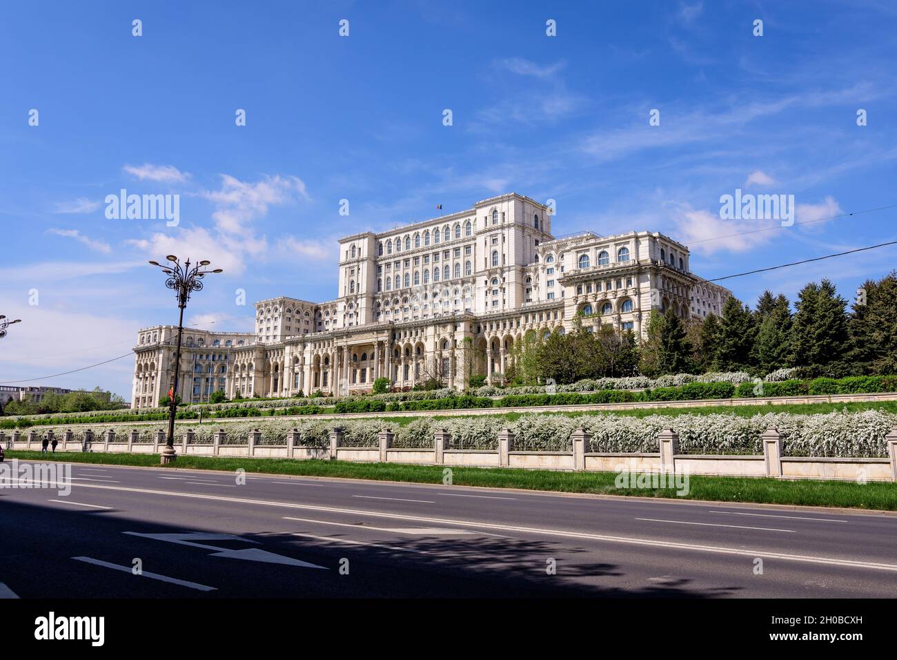 The Palace of the Parliament also known as People's House (Casa Popoprului) in Constitutiei Square (Piata Constitutiei) in Bucharest, Romania, in a su Stock Photo