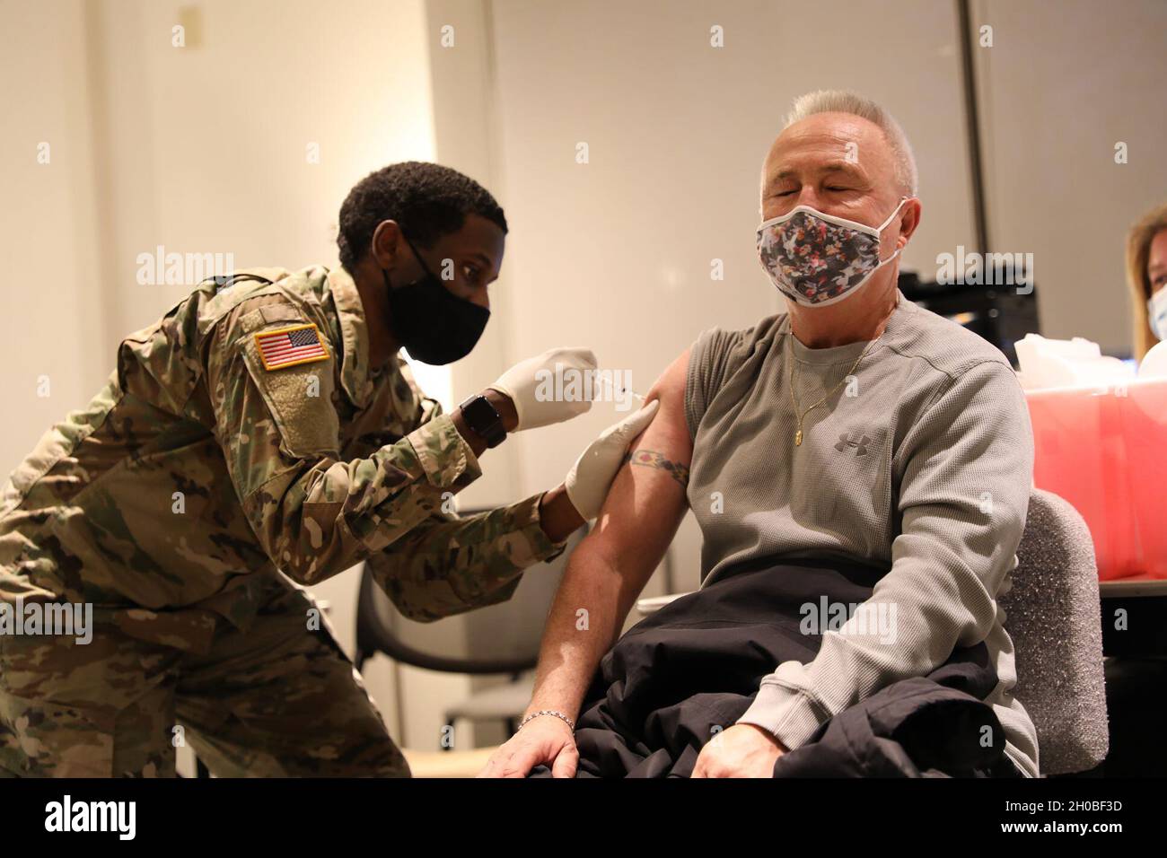 Spc. Anthony Shepherd, a medic assigned to the 224th Medical Company Area Support, Maryland Army National Guard, administers a COVID-19 vaccine Jan. 18, 2021, at Anne Arundel Community College in Arnold, Md. Maryland Guard members are supporting the COVID-19 vaccination initiative with mobile vaccination support teams, which are providing medical and logistical support to county health departments during the global COVID-19 pandemic. Stock Photo