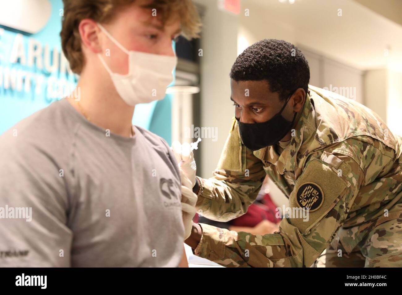 Spc. Anthony Shepherd, a medic assigned to the 224th Medical Company Area Support, Maryland Army National Guard, administers a COVID-19 vaccine Jan. 18, 2021 at Anne Arundel Community College in Arnold, Md. Maryland Guard members are supporting the COVID-19 vaccination initiative with mobile vaccination support teams, which are providing medical and logistical support to county health departments during the global COVID-19 pandemic. Stock Photo