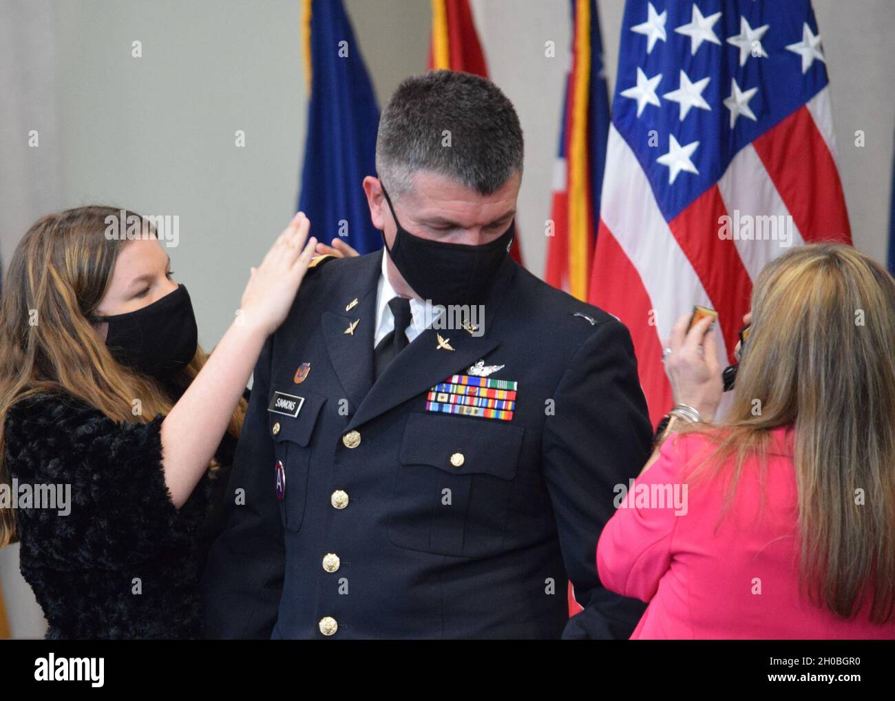Georgia Army National Guard Col. Barry Simmons receives his new rank from his wife Michelle and daughter Allison during a promotion ceremony at the Clay National Guard Center in Marietta, Ga. Jan. 19, 2021. Stock Photo