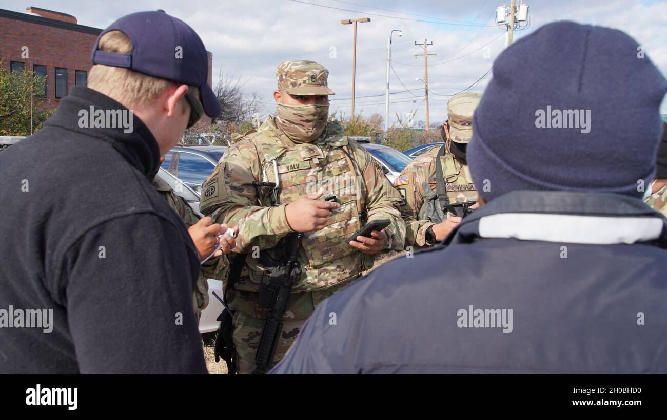 U.S. Army Staff Sgt. Atui Valu coordinates with the Virginia State Police, Arlington, Virginia, Jan. 19, 2021. At least 25,000 National Guard men and women have been authorized to conduct security, communication and logistical missions in support of federal and District authorities leading up and through the 59th Presidential Inauguration. Stock Photo