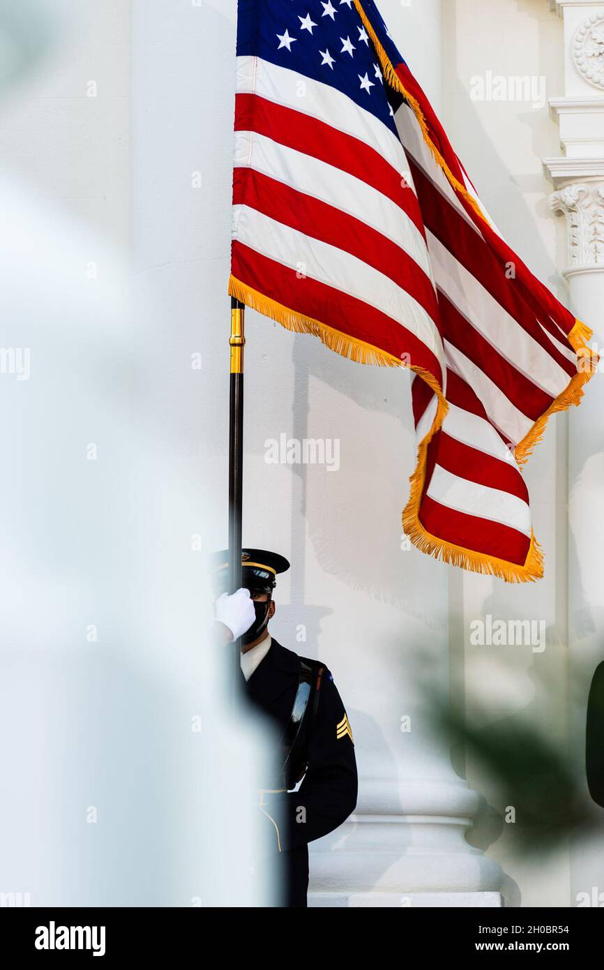 A U.S. service member with the Joint Armed Forces Honor Guard renders honors during an Armed Forces Full Honor Arrival Ceremony, honoring President Joseph R. Biden, Jr., at the White House during the 59th Presidential Inauguration in Washington, D.C., Jan. 20, 2021. Stock Photo