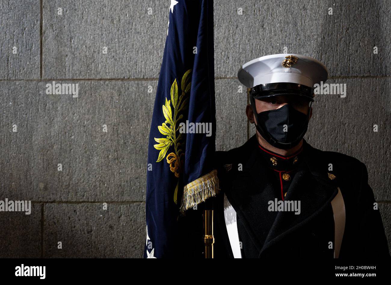 A U.S. Marine White House military office sentry holds a flag during