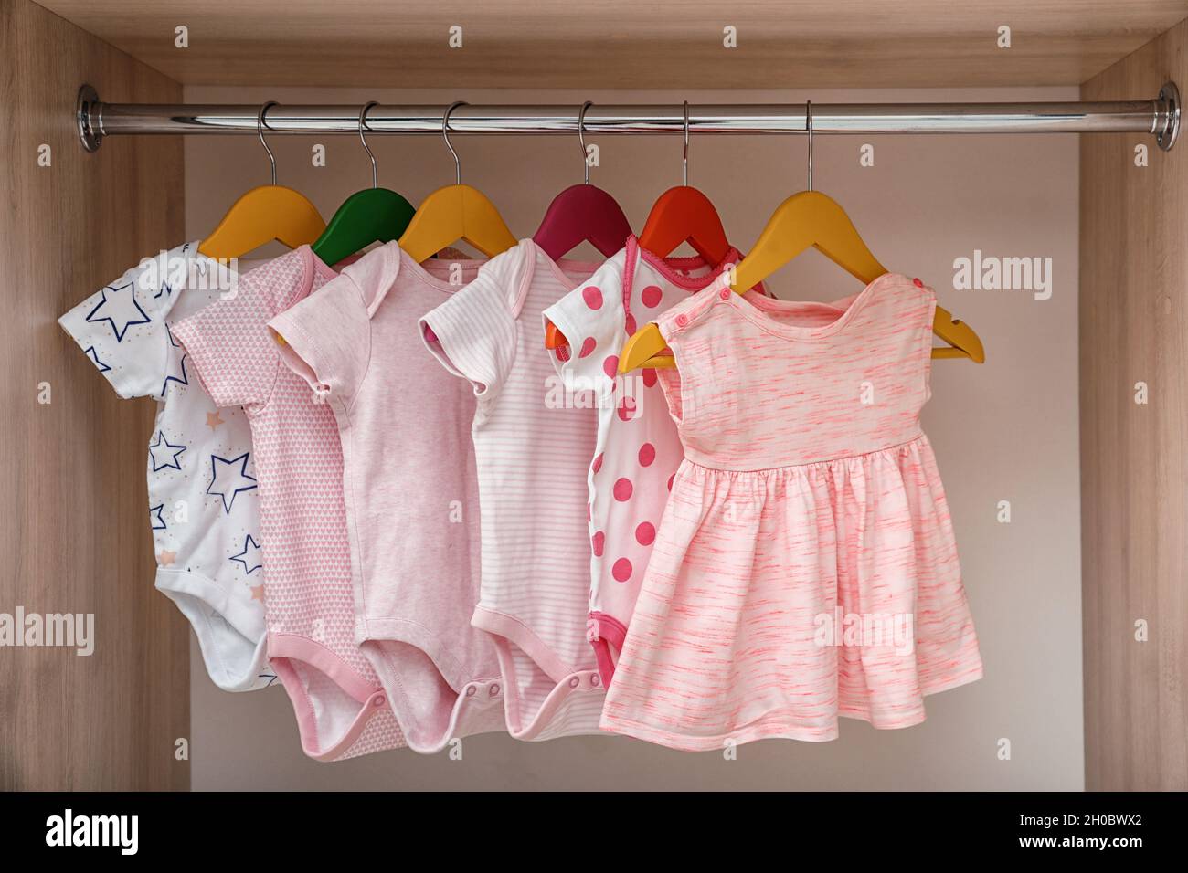 Hangers with Baby Clothes on Rack Stock Photo - Image of garments, inside:  132793586