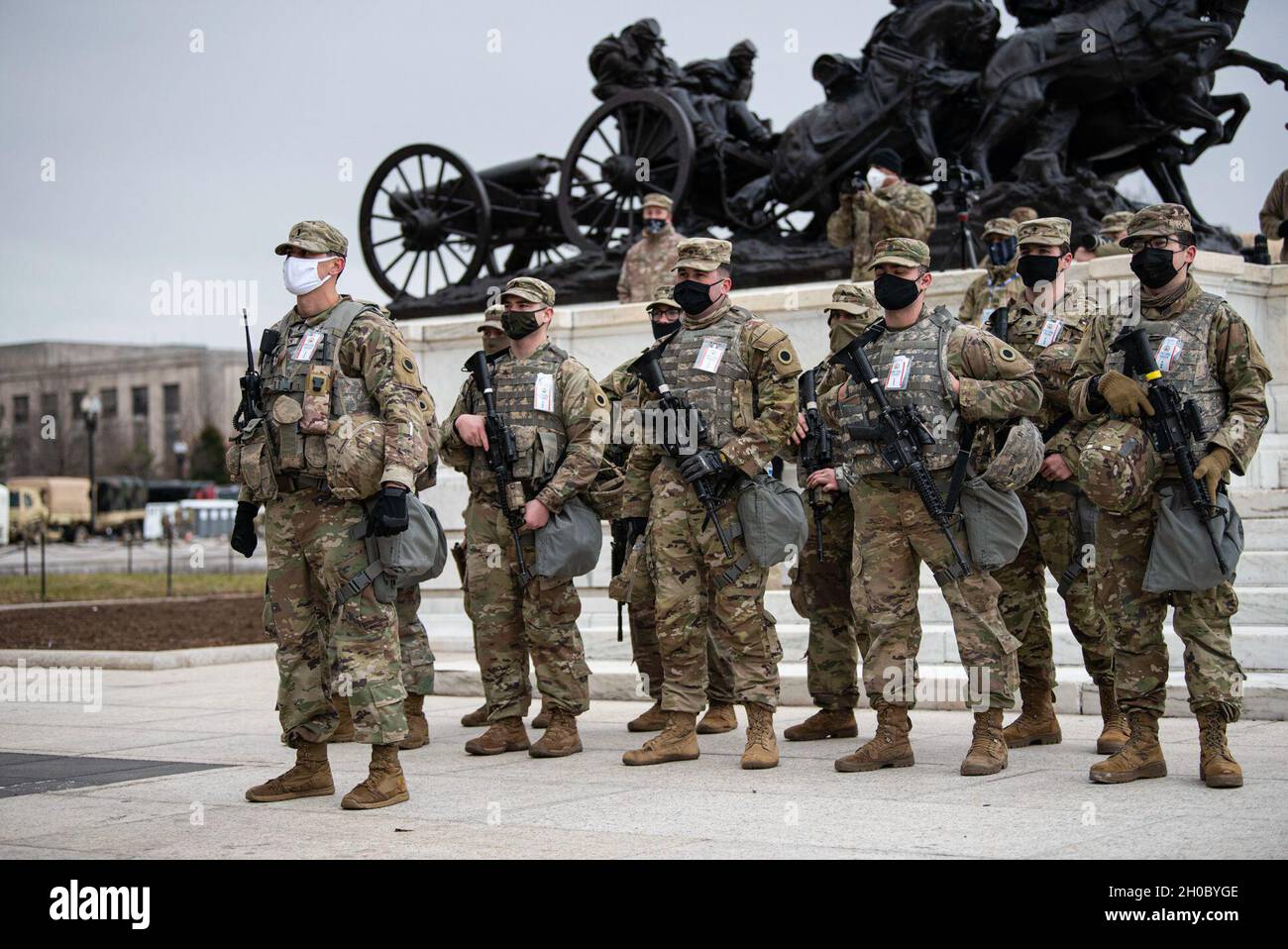 U.S. Soldiers assigned to 2nd Squadron, 107th Cavalry Regiment, Ohio  National Guard, watch the 59th Presidential Inauguration near the U.S.  Capitol building in Washington, D.C., Jan. 20, 2021. At least 25,000  National, image size:1300x958