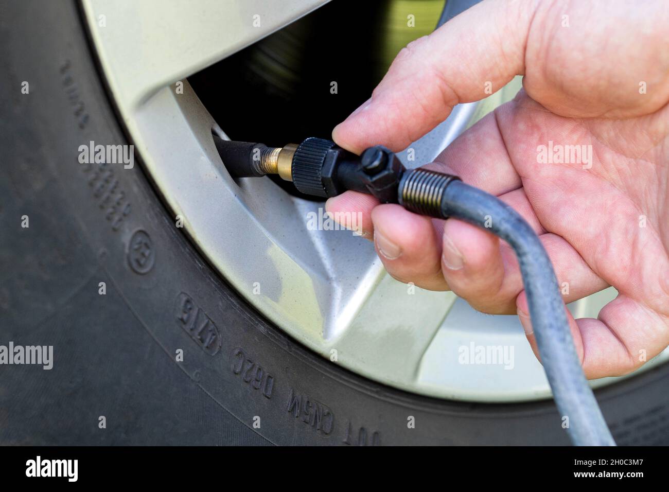 connecting the hose to the wheel spool of a car for inflating the wheel