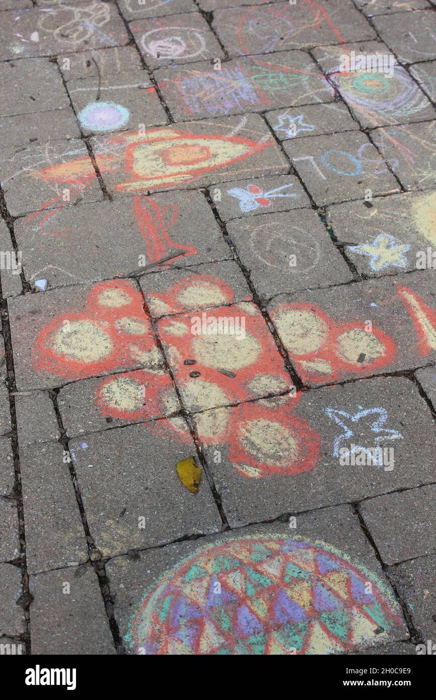 Kid sidewalk chalk drawing of space travel with a rocket ship as a fun ...