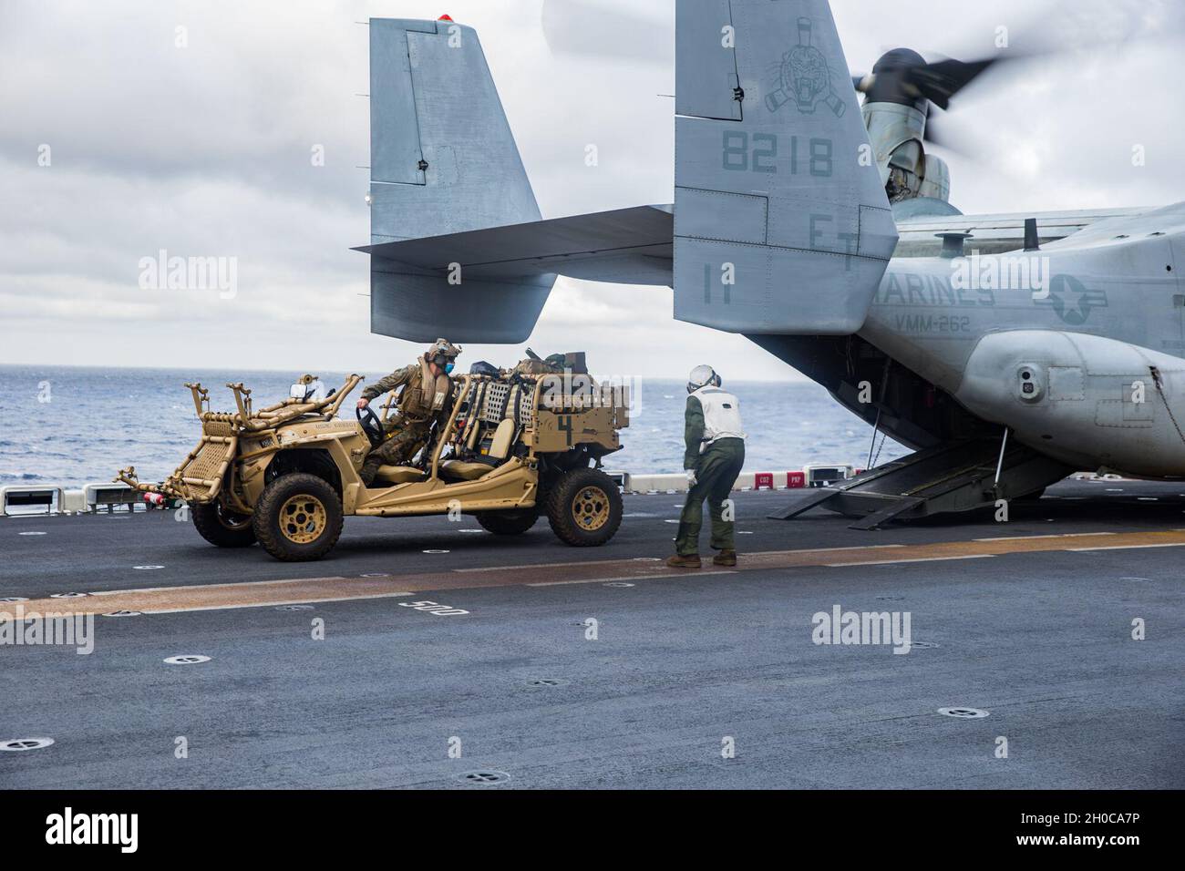 U.S. Marines with the 31st Marine Expeditionary Unit (MEU) load a light ...