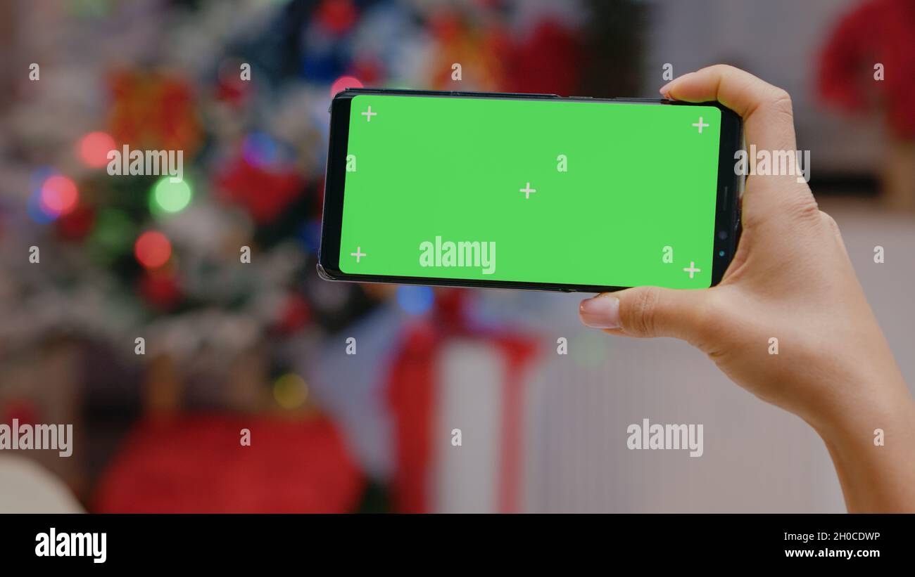 Hand presents smartphone green screen hi-res stock photography and ...
