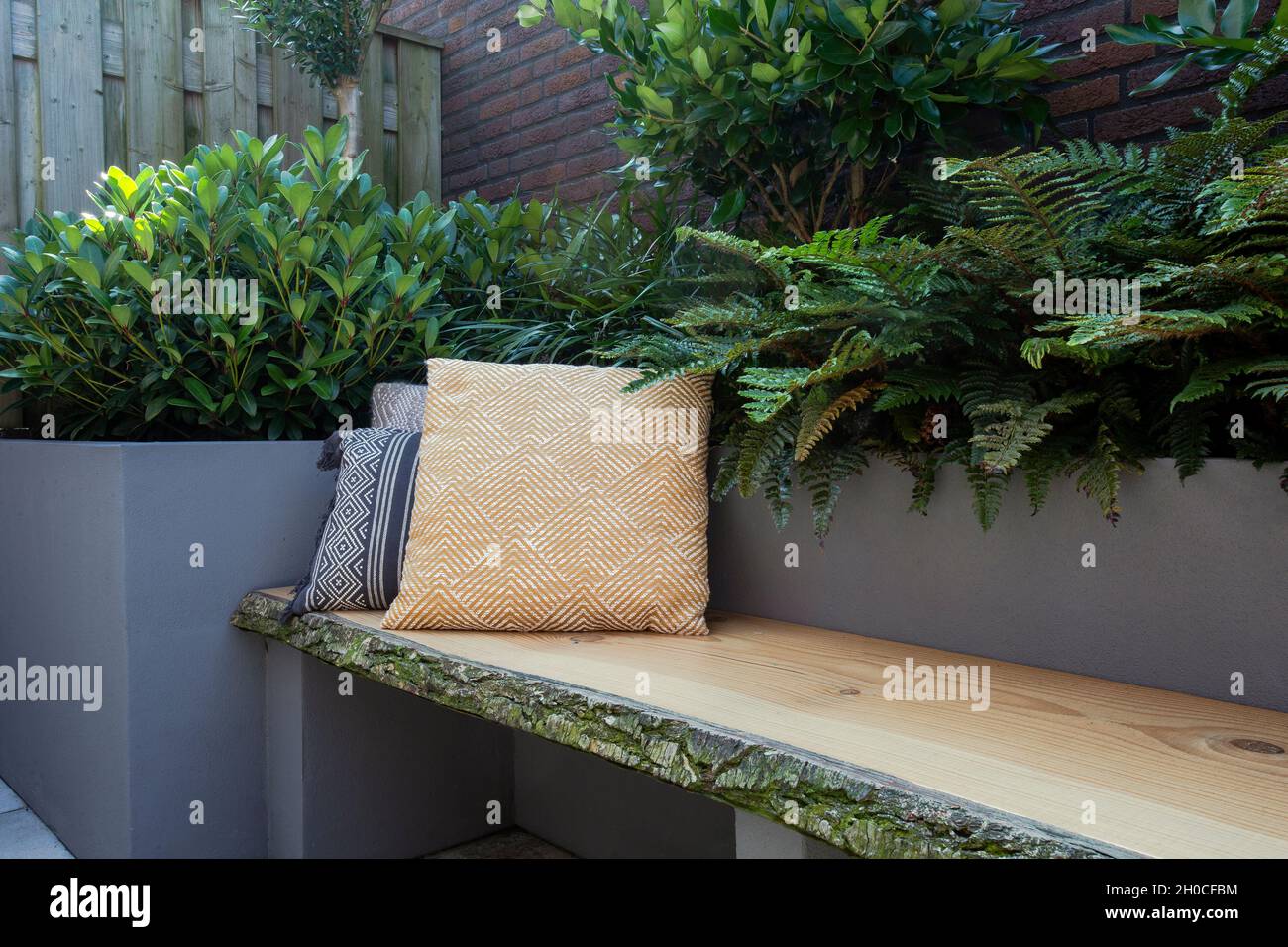 Cozy seating, Wooden sofa with colorful pillows in cozy garden seat