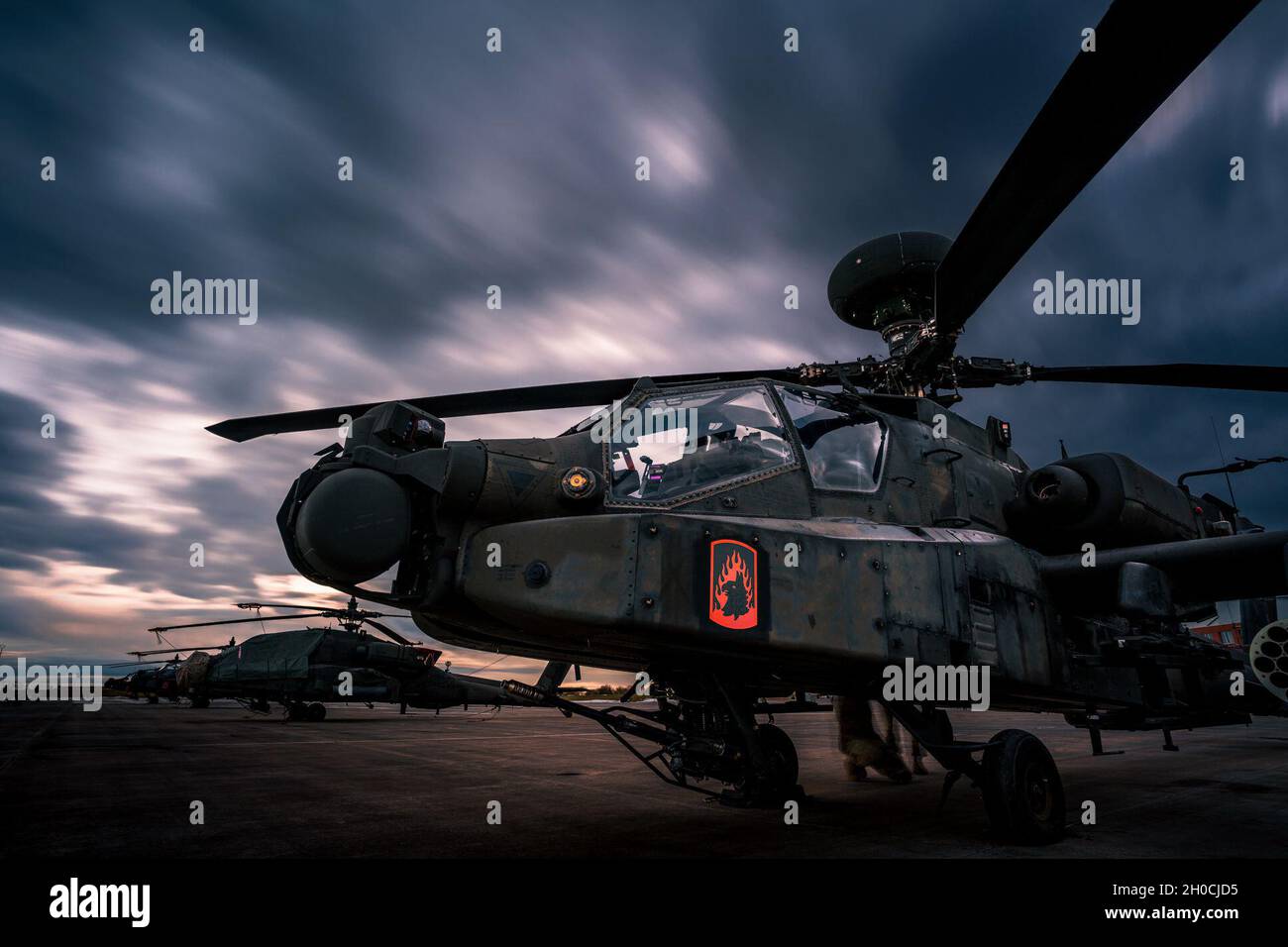 An AH-64 Apache Longbow of the 12th Combat Aviation Brigade, 'Wings of Victory,' is prepped to move into a hangar as an impending snow storm moves in on Jan. 22 at Katterbach Army Airfield, Germany. Stock Photo