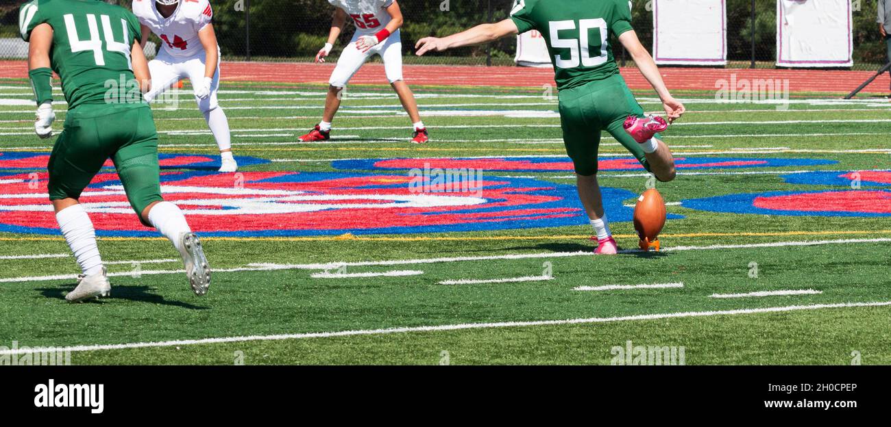 A high school football player is kicking the ball during A high school football player is kicking the ball during