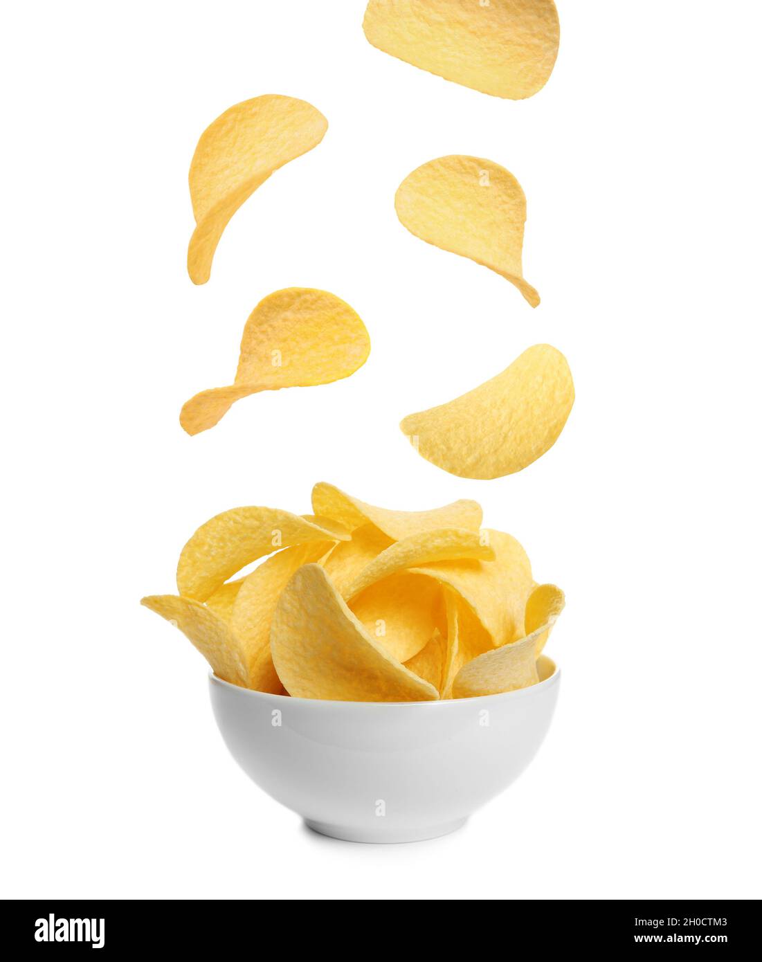 Tasty potato chips falling into blow on white background Stock Photo