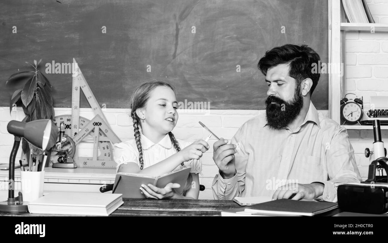 education child development. back to school. bearded man teacher with small girl in classroom. knowledge day. Home schooling. daughter study with Stock Photo