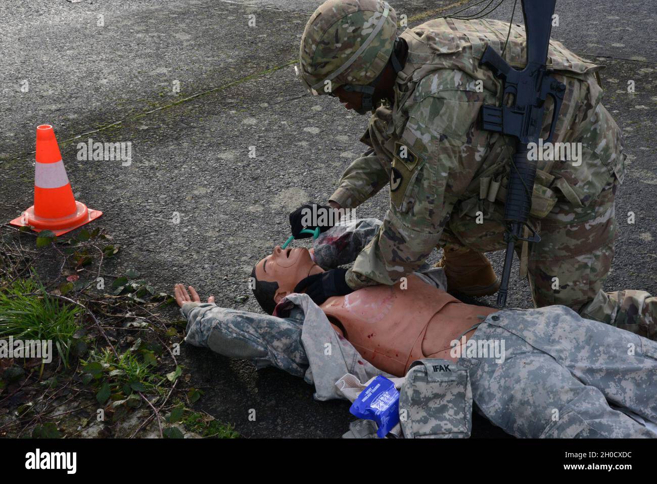 U.S. Army Pfc. Arnando Smith assigned to U.S Army Garrison Benelux (Chièvres), installs a naso pharyngeal airway on victim during the Best Warrior Competition, on Chièvres Air Base, Belgium, Jan. 26, 2021. Stock Photo