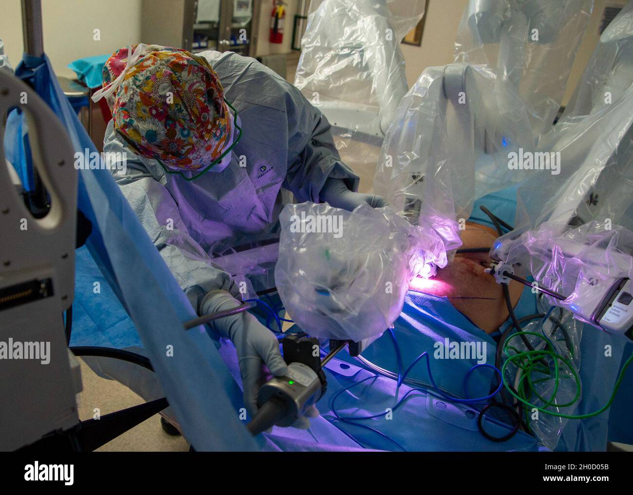 210127-N-LW757-1134  SAN DIEGO (Jan. 27, 2020) Lt. j.g. Alessa Andersen, a registered nurse assigned to Naval Medical Center San Diego's (NMCSD) Main Operating Room, inserts a laparoscopic camera into one of the arms of a robotic surgery system during a robotic-assisted laparoscopic inguinal hernia repair procedure in one of the hospital's operating rooms Jan. 27. Robotic surgical systems, like those used at NMCSD, allow surgeons to perform minimally-invasive procedures, and this procedure was performed during a remote, tele-mentoring study. NMCSD’s mission is to prepare service members to dep Stock Photo