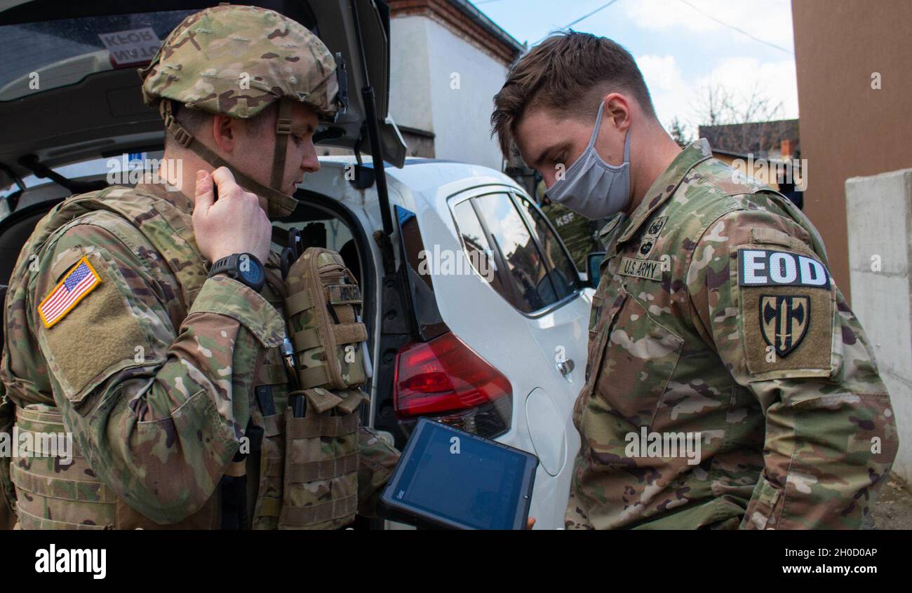 Sgt. Mark Henderson and 1st Lt. Taylor Firn, Soldiers with the explosive ordnance disposal team attached to Regional Command-East, Kosovo Force, examine the X-ray of an explosive ordnance during an EOD emergency call in Gjilan/Gnjilane, Kosovo, on Jan. 27, 2021. The EOD team takes all possible safety measures to ensure everyone remains safe throughout the mission. The 702nd Ordnance Company, based out of Grafenwoehr, Germany, is supporting the NATO-led KFOR mission, which is dedicated to ensuring freedom of movement for all people in Kosovo. Stock Photo