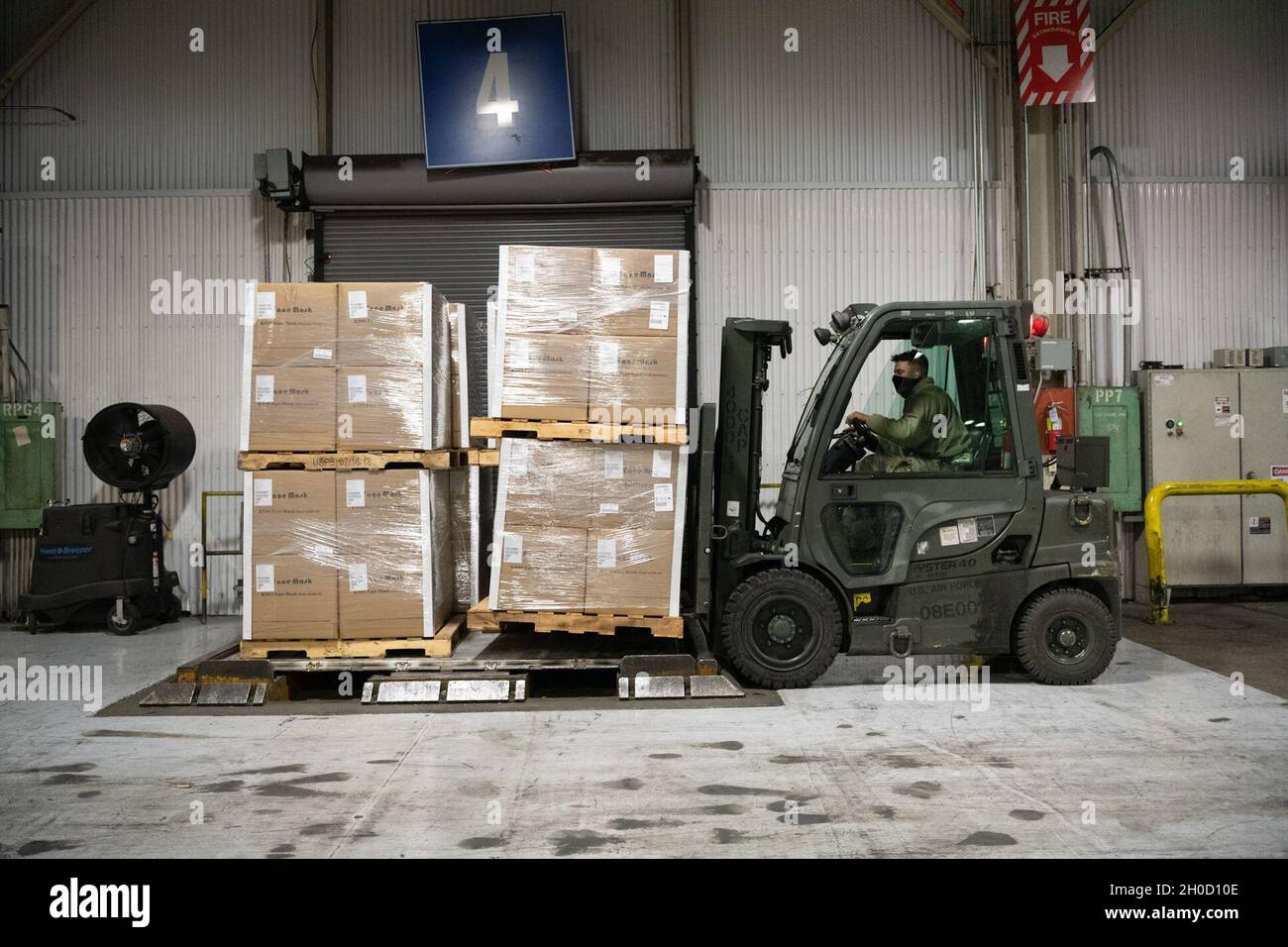 U.S. Air Force Senior Airman Devrick Sayles, 60th Aerial Port Squadron cargo operations journeyman, operates a forklift during pallet build up Jan. 27, 2021, Travis Air Force Base, California. The 60th APS palletized one million N-95 masks bound for Ramstein Air Base, Germany. Stock Photo