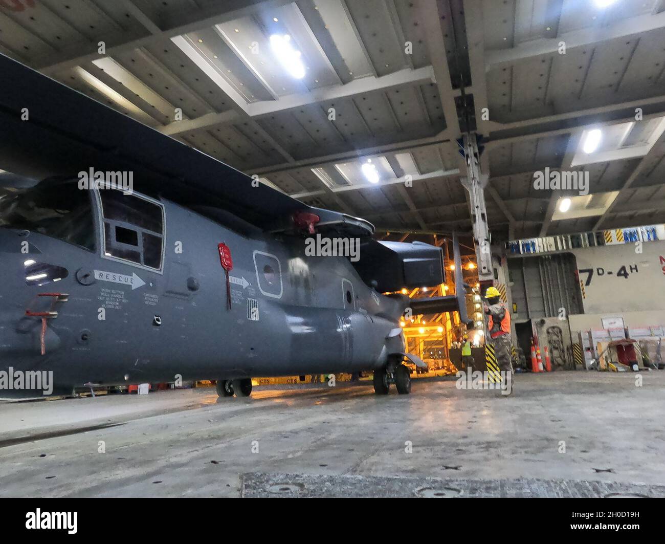 Offloading Operations Air Force mechanics guide the movement of a CV-22 Osprey aboard the ...