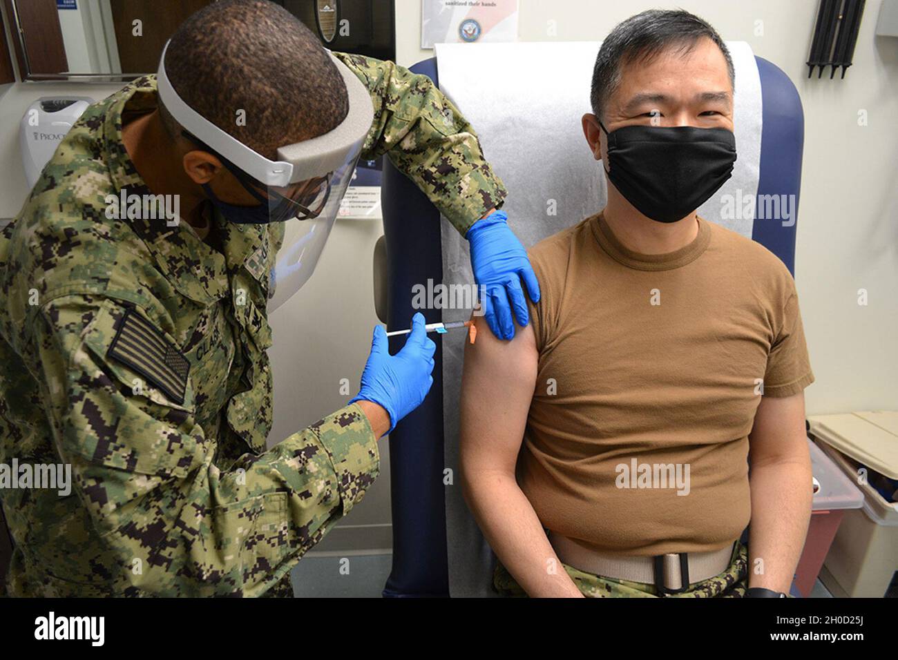 210128-N-CC785-0002 GREAT LAKES, Ill. (Jan. 28, 2021) - Capt. Ray Leung, Naval Station Great Lakes commanding officer, received the coronavirus vaccine at Fisher Clinic. Stock Photo