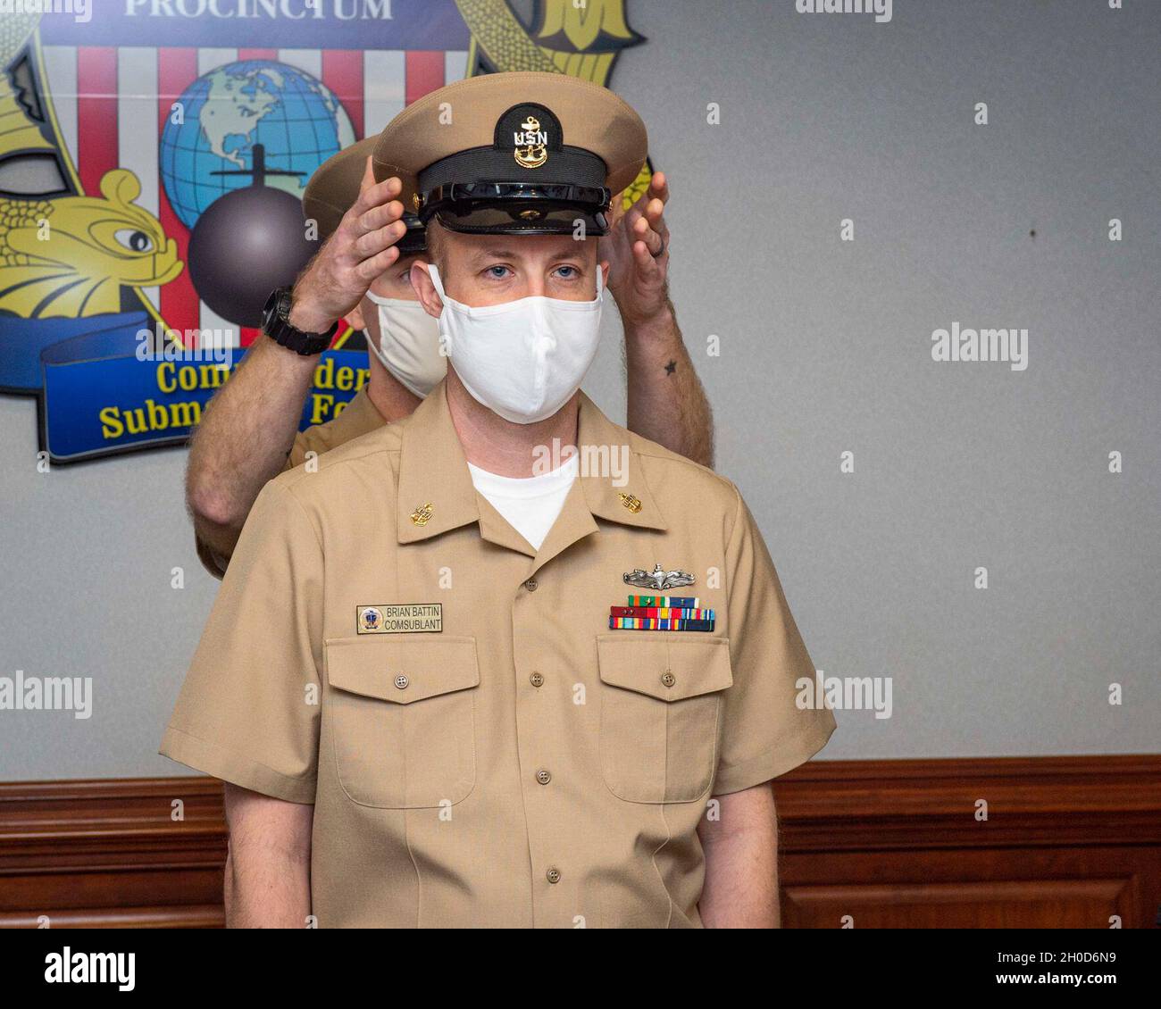 Chief Yeoman Brian Battin receives his combination cover during a chief