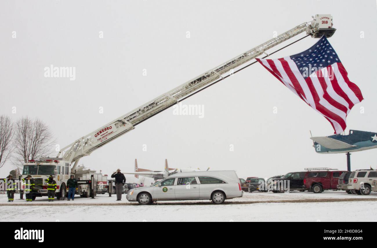 Members of the Geneseso, NY Fire Department and the New York State Police salute a passing hearse carrying the remains of Chief Warrant Officer 4 Christian Koch, Jan. 29. Koch, a UH-60 Blackhawk pilot assigned to Charlie Company, 1-171 General Support Aviation Battalion, died when his helicopter crashed during a training flight Jan. 20 outside Rochester, NY Stock Photo