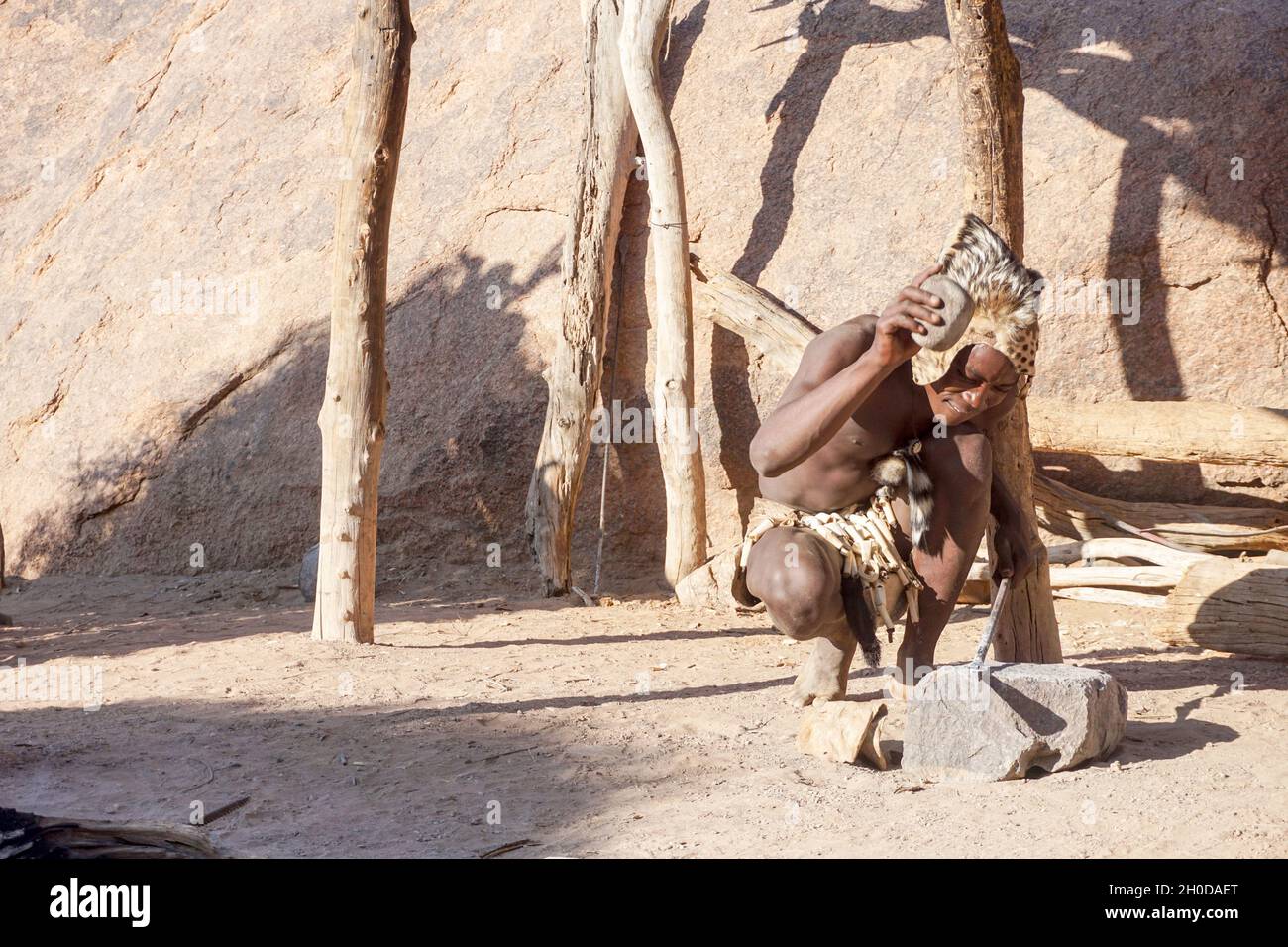 Craftsman of Tribu 'Damara at work, UNESCO World Heritage Site, Twyfelfontein, Damaraland, Namibia, Africa Stock Photo