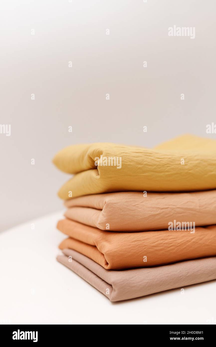 Stacks colorful cotton fabric, clothes. Copyspace Stock Photo Alamy