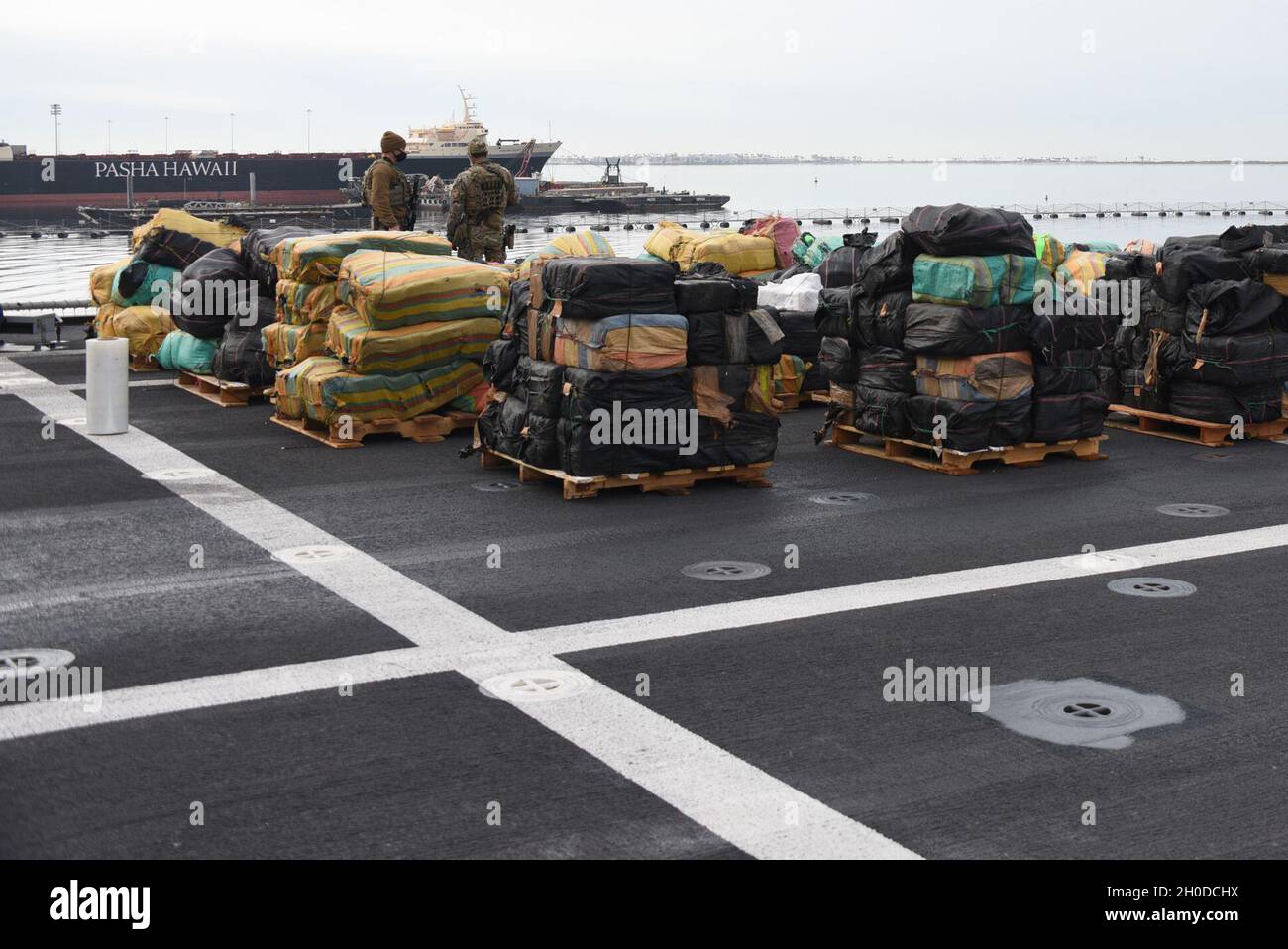 U.S. Coastguardsmen with Law Enforcement Detachment 407 (LEDET) offloads 11,400 pounds of cocaine and 9,000 pounds of marijuana in San Diego, Feb. 1, 2021. The alleged narcotics were seized in international waters of the Eastern Pacific Ocean and are worth more than $211 million. (Coast Guard video by Petty Officer 3rd Class Alex Gray) Stock Photo