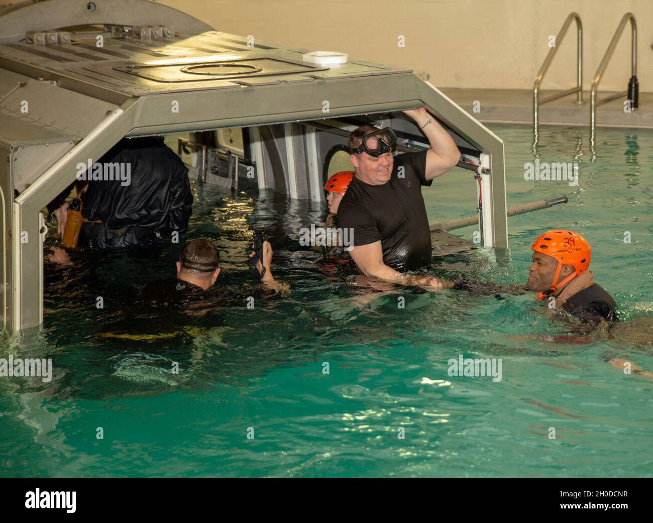 U.S. Marines enter the Modular Amphibious Egress Trainer during