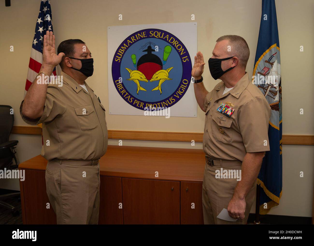 NAVAL BASE GUAM, Guam (Feb. 2, 2021) - Chief Warrant Officer Andrew De La O, from San Antonio, Texas (left), and Capt. Bret Grabbe, commander, Submarine Squadron 15, recite the oath of office during a promotion ceremony held at Konetzni Hall. Commander, Submarine Squadron 15 is responsible for providing training, material, and personnel readiness support to multiple Los Angeles-class fast-attack submarine commands located at Polaris Point, Naval Base Guam. Stock Photo
