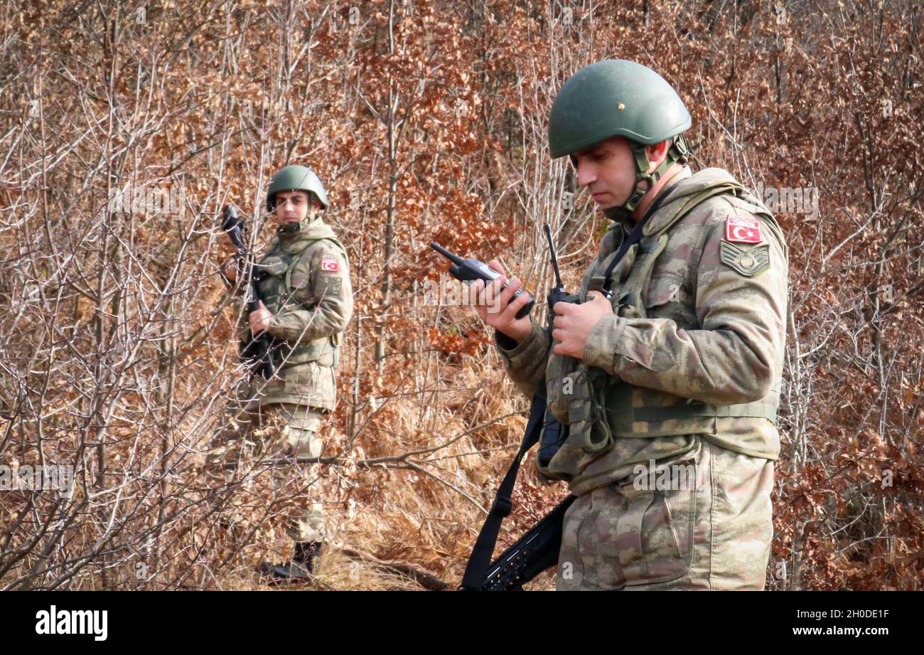 A Turkish Armed Forces soldier assigned to Regional Command-East, Kosovo  Force, performs a land mobile radio check during a foot patrol along the  administrative boundary line in Kosovo on Feb. 1, 2021.